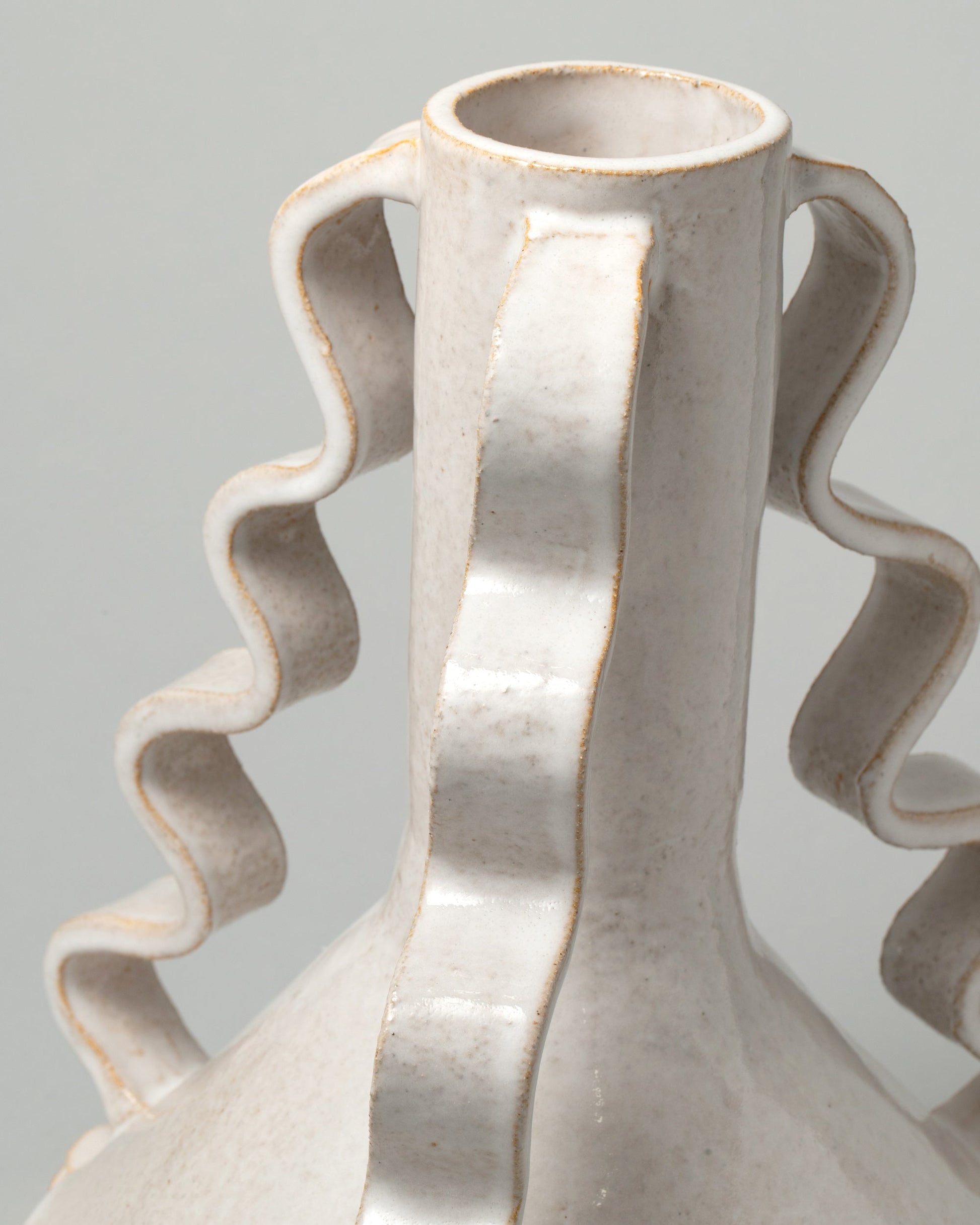 Closeup details of the Morgan Peck Pearl Swoop Vase on light color background.