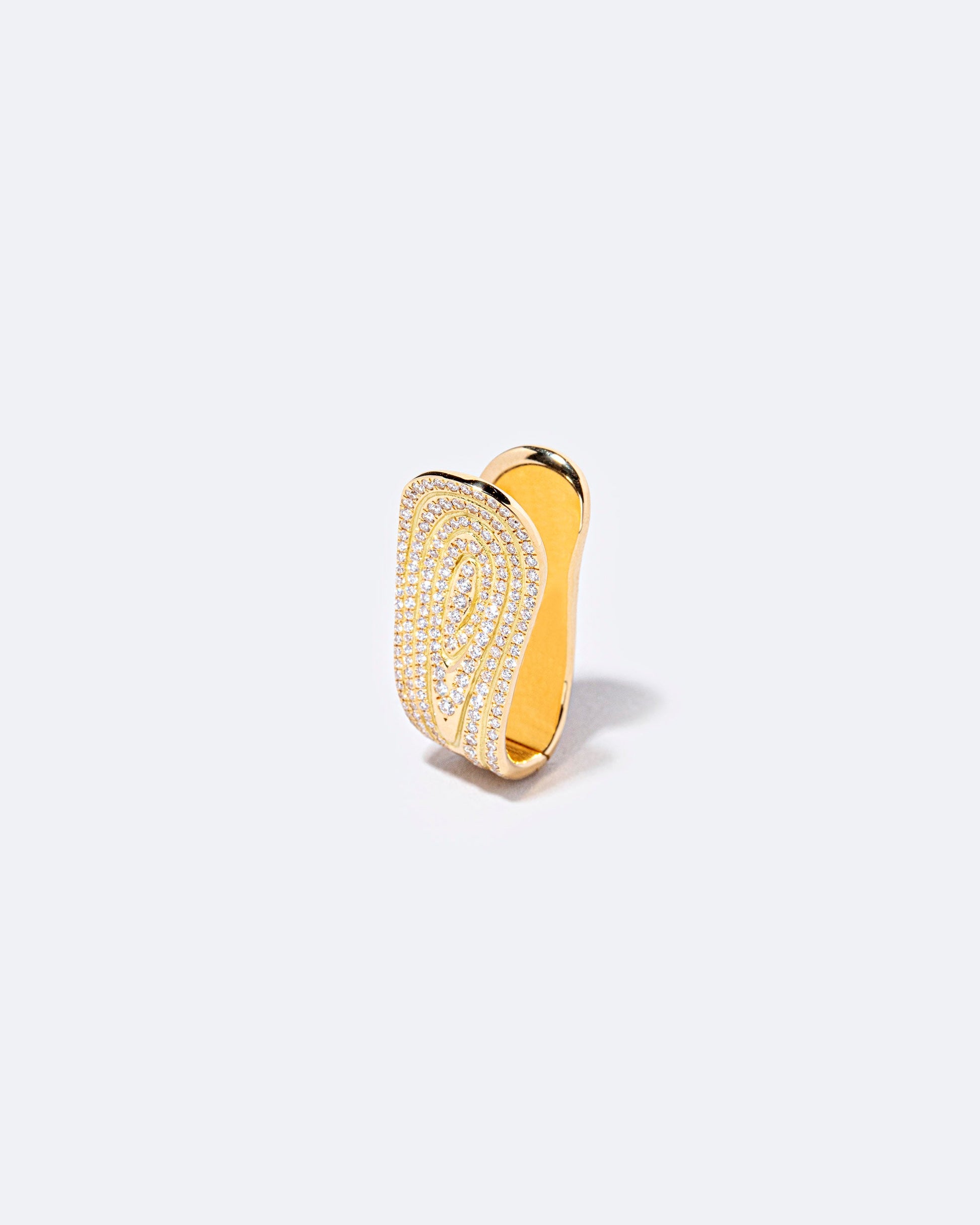 Closeup details of the White Diamond Duality Hoop Earring on light color background.