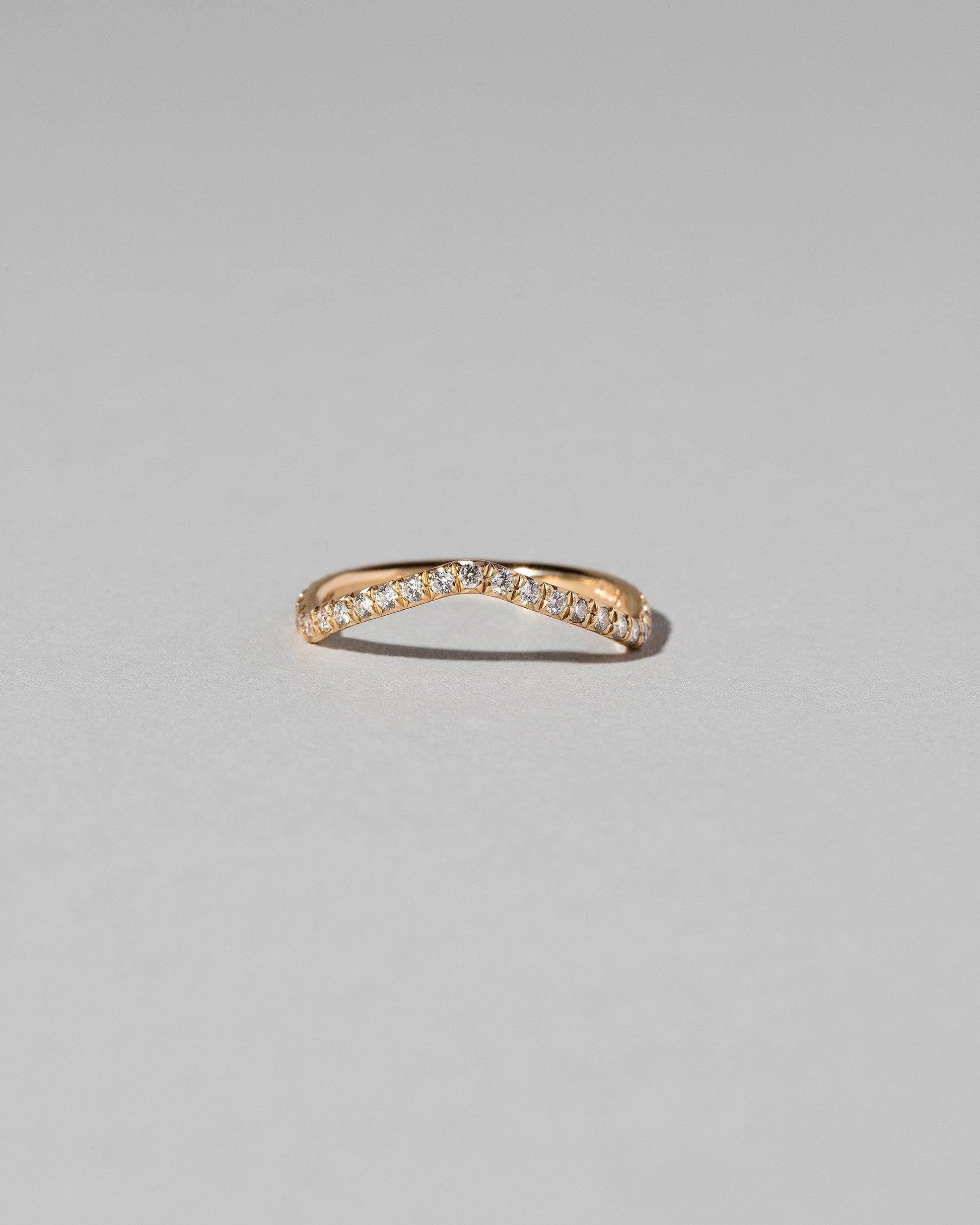 Gold Pavé White Diamond Low Peak Band on light color background.