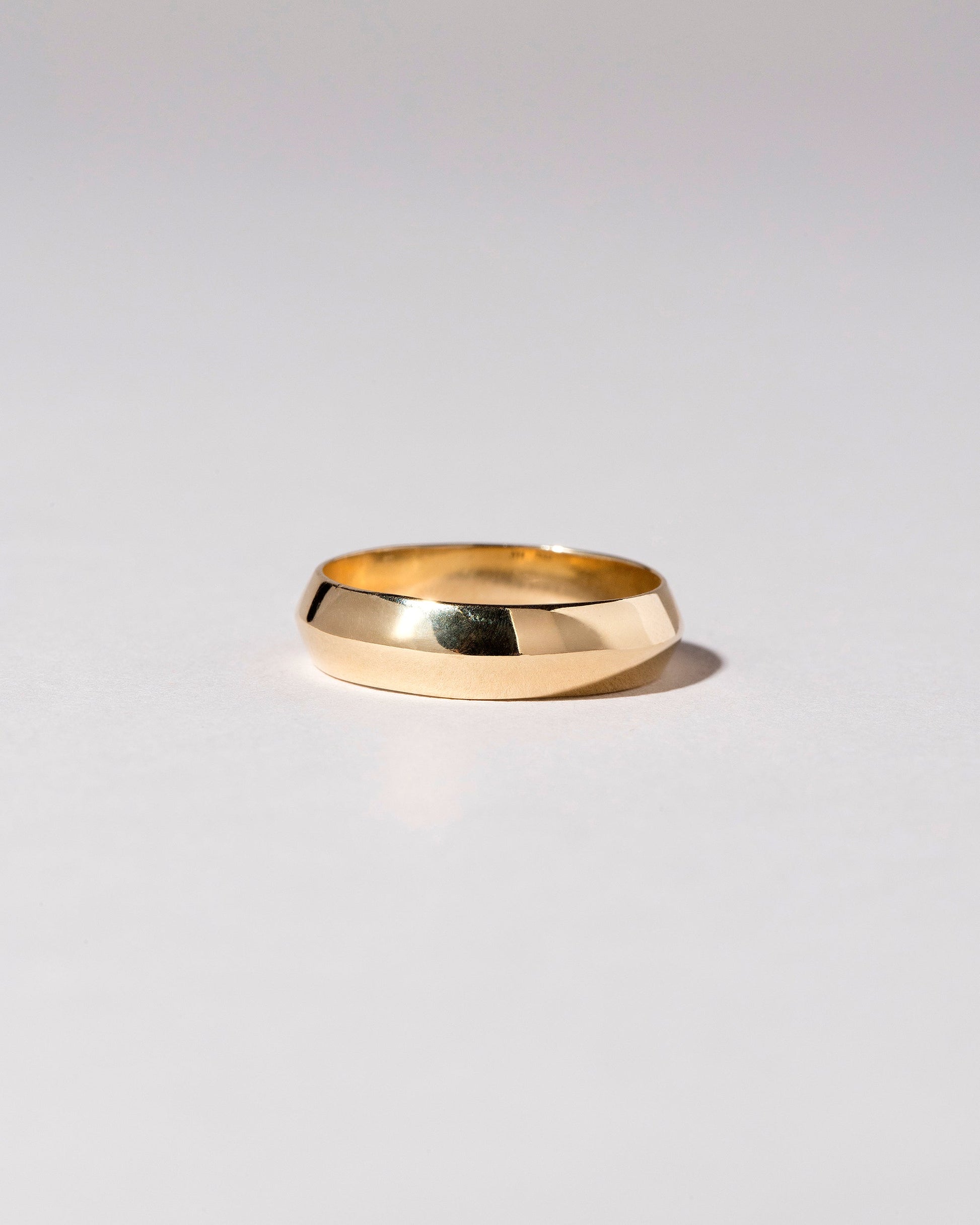 Gold 6mm Knife Edge Band on light color background.