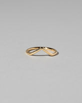 Gold Solid Round Wire High Peak Band on light color background.