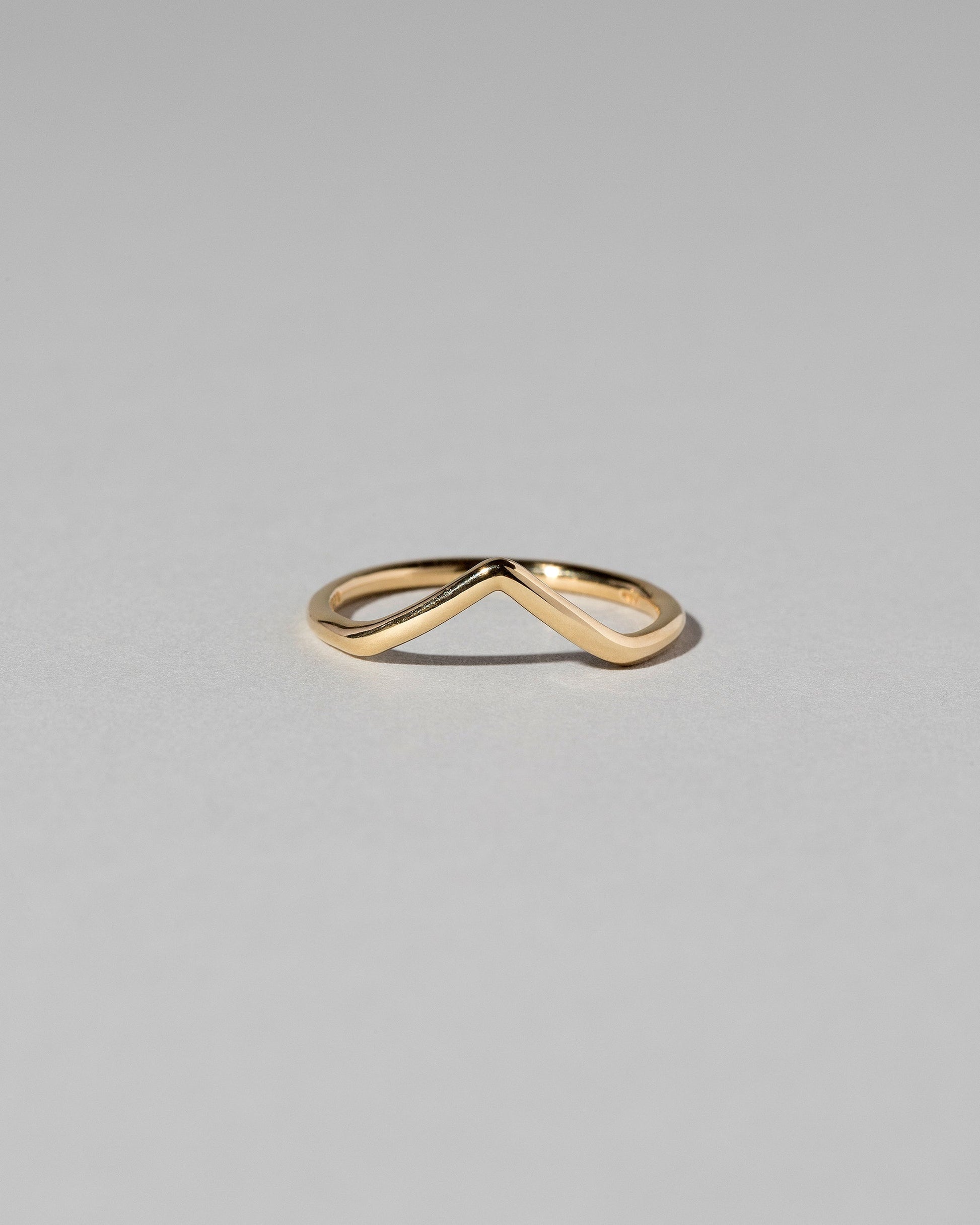 Gold Solid Round Wire High Peak Band on light color background.