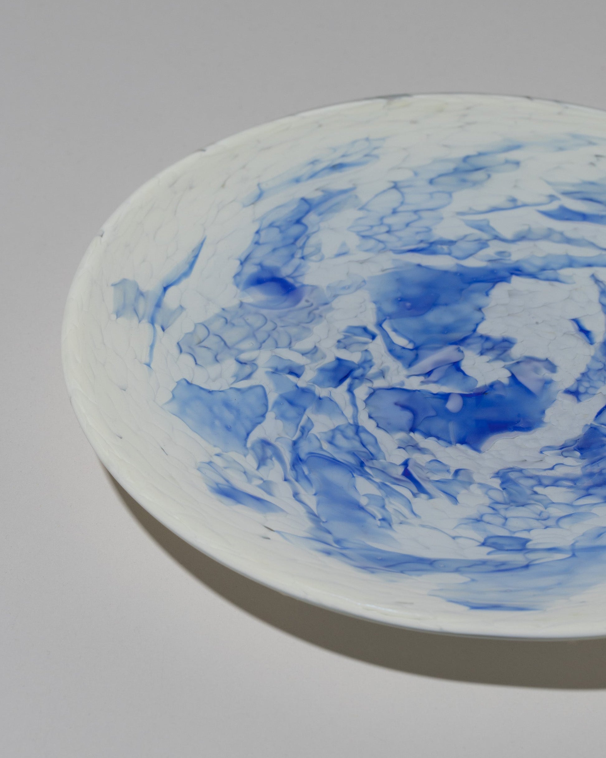 Closeup detail of the Stories of Italy Blue Nougat Dessert Plate on light color background.