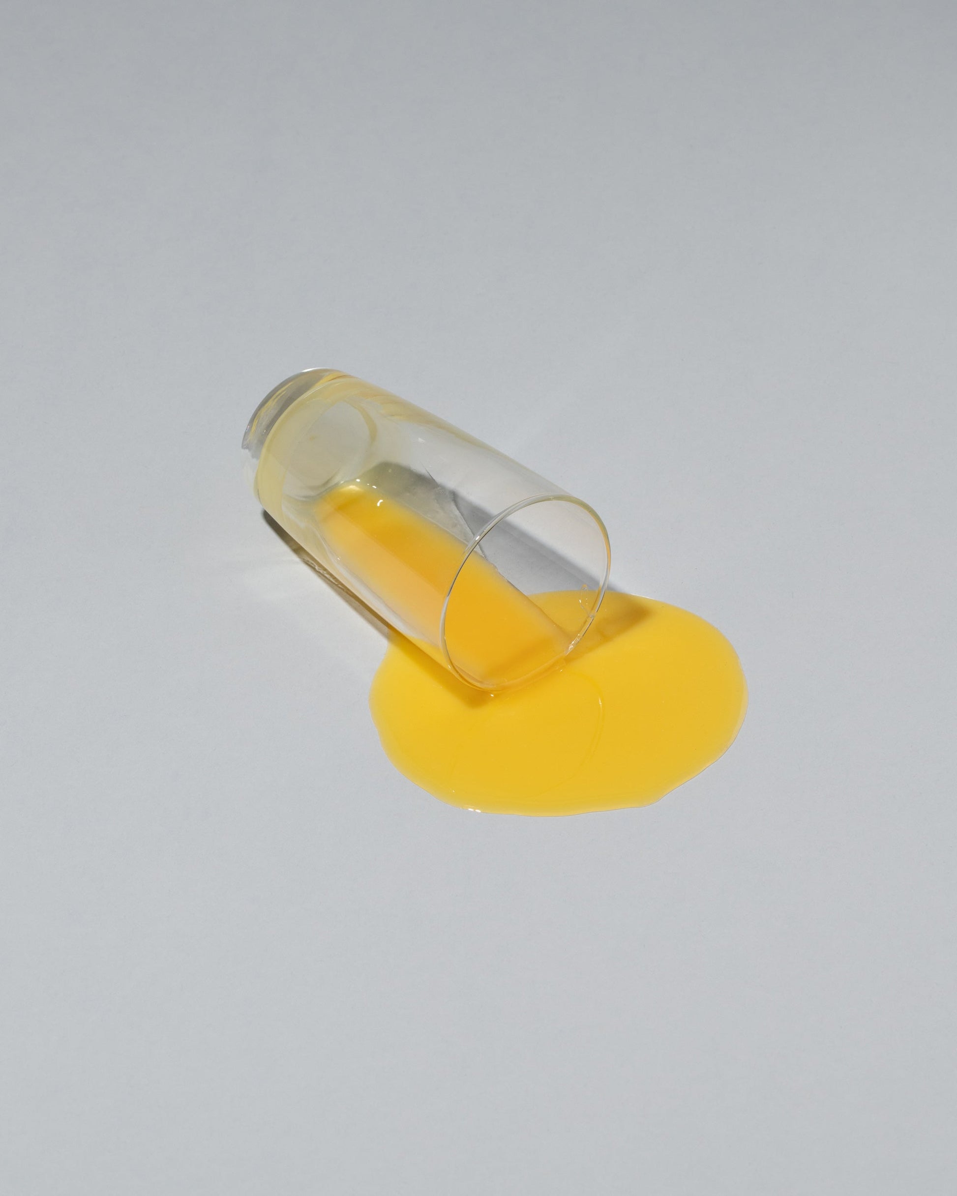 Spills Faux Diner Orange Juice Spill on light color background.