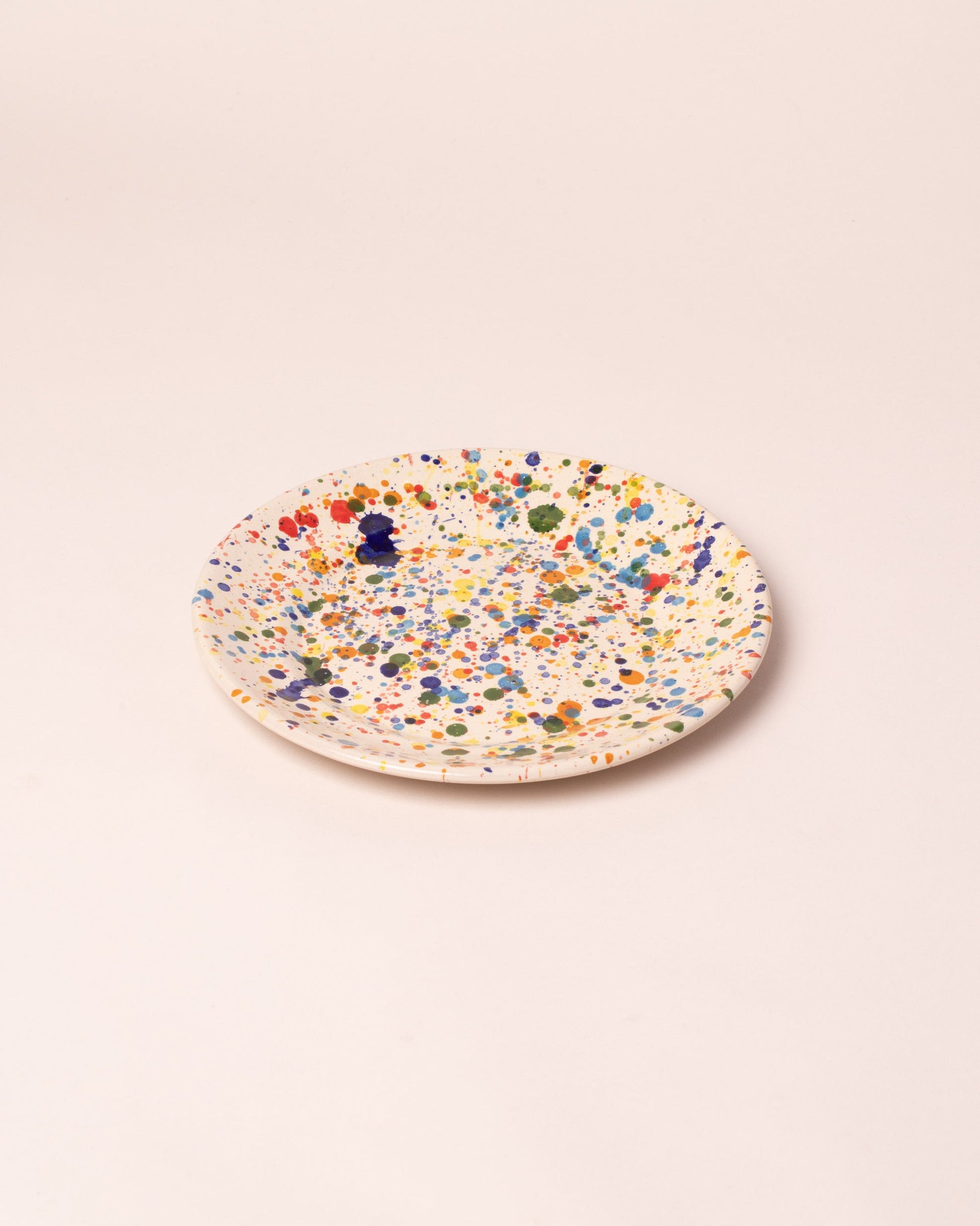 Closeup details of the La Ceramica Vincenzo Del Monaco Colored Drops Medium Dish on light color background.