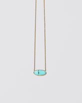 Waters Necklace on light color background.