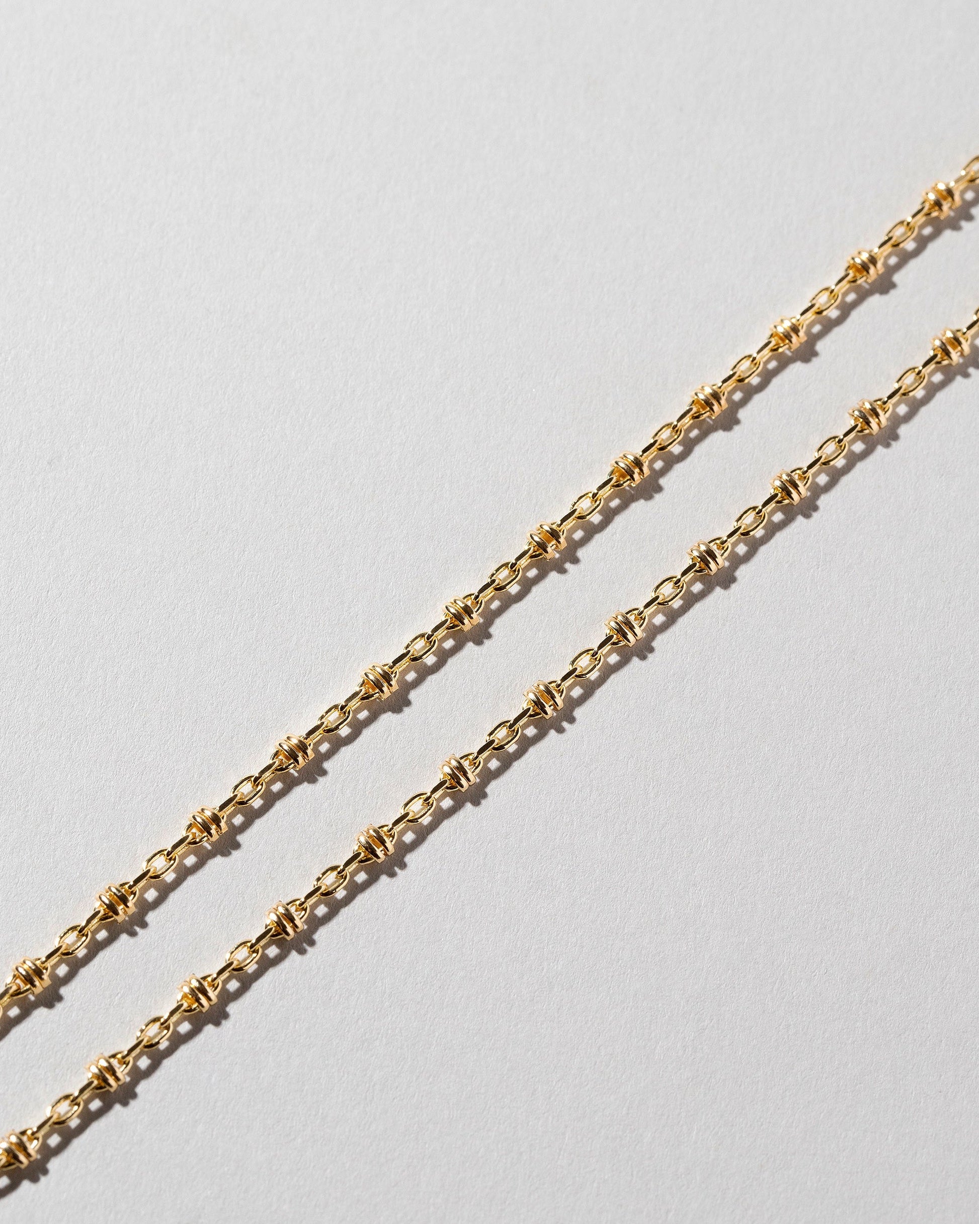 Wrapped Chain Necklace on light color background.