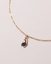 Closeup detail of the Stone Crab Claw Charm styled with the Abacus Chain Necklace on light color background.