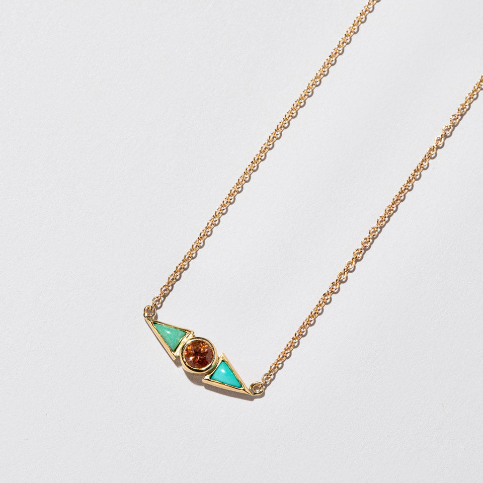 product_details:: Sunstone & Turquoise Eye Necklace on light color background.
