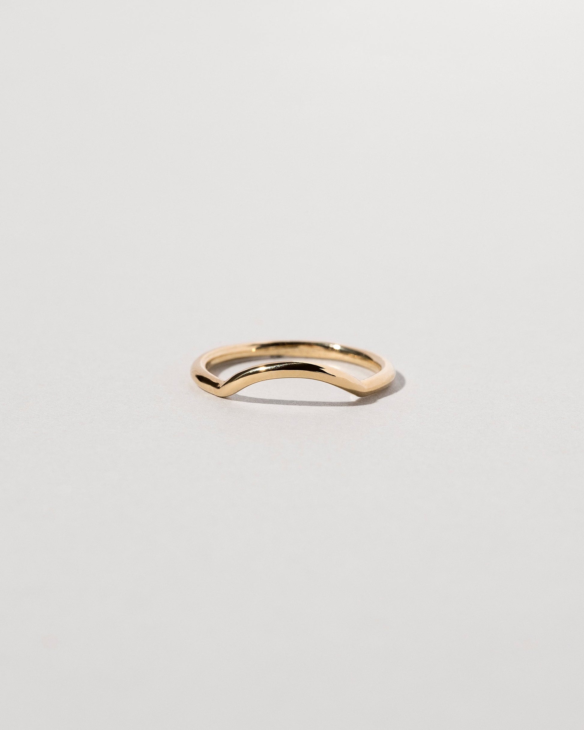 Gold Solid Round Wire Mini Curve Band on light color background.