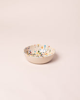 La Ceramica Vincenzo Del Monaco Colored Drops Cereal Bowl on light color background.