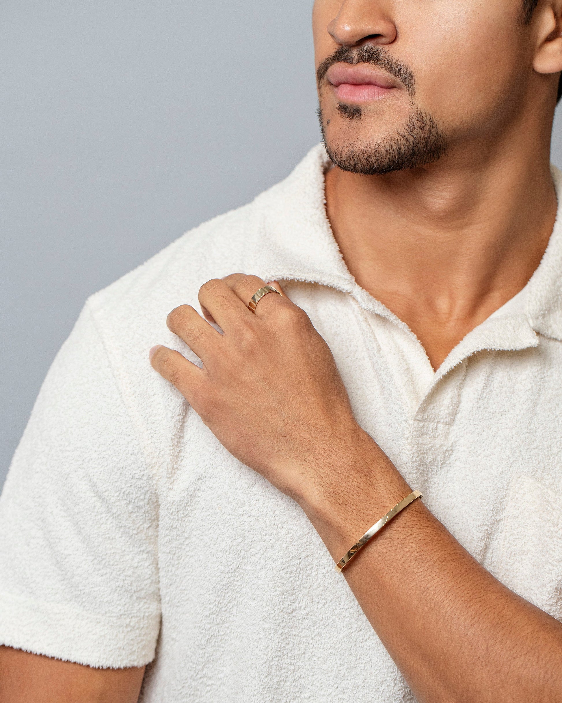 Loop Bracelet and Gold 5mm Etched Lines Band on male model. 