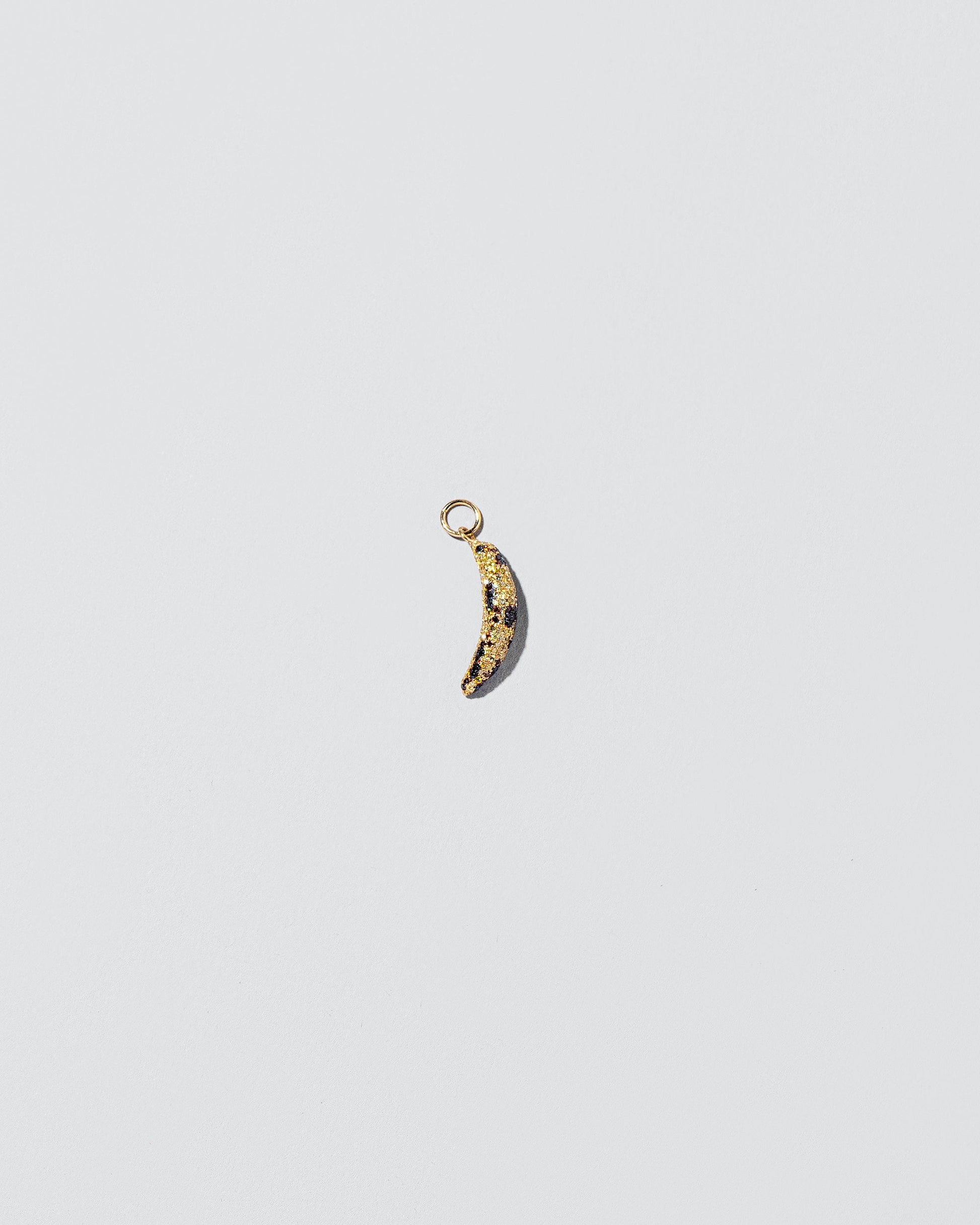 Bruised Banana Charm on light color background.