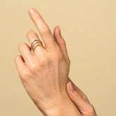 product_details::Gold Three Stone Low Peak Bands on model.