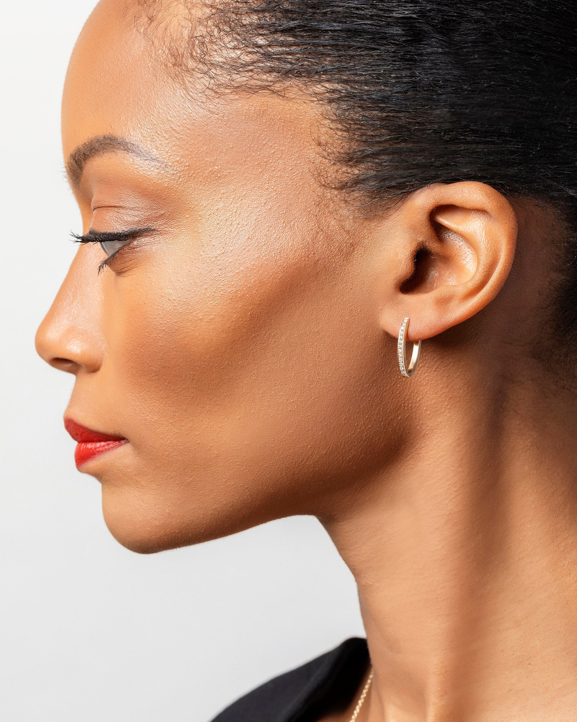 Gold White Diamond Tiny Loop Hoop Earrings on model.