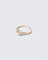 View from the side of the Grand White Diamond Barragán Ring on light color background.