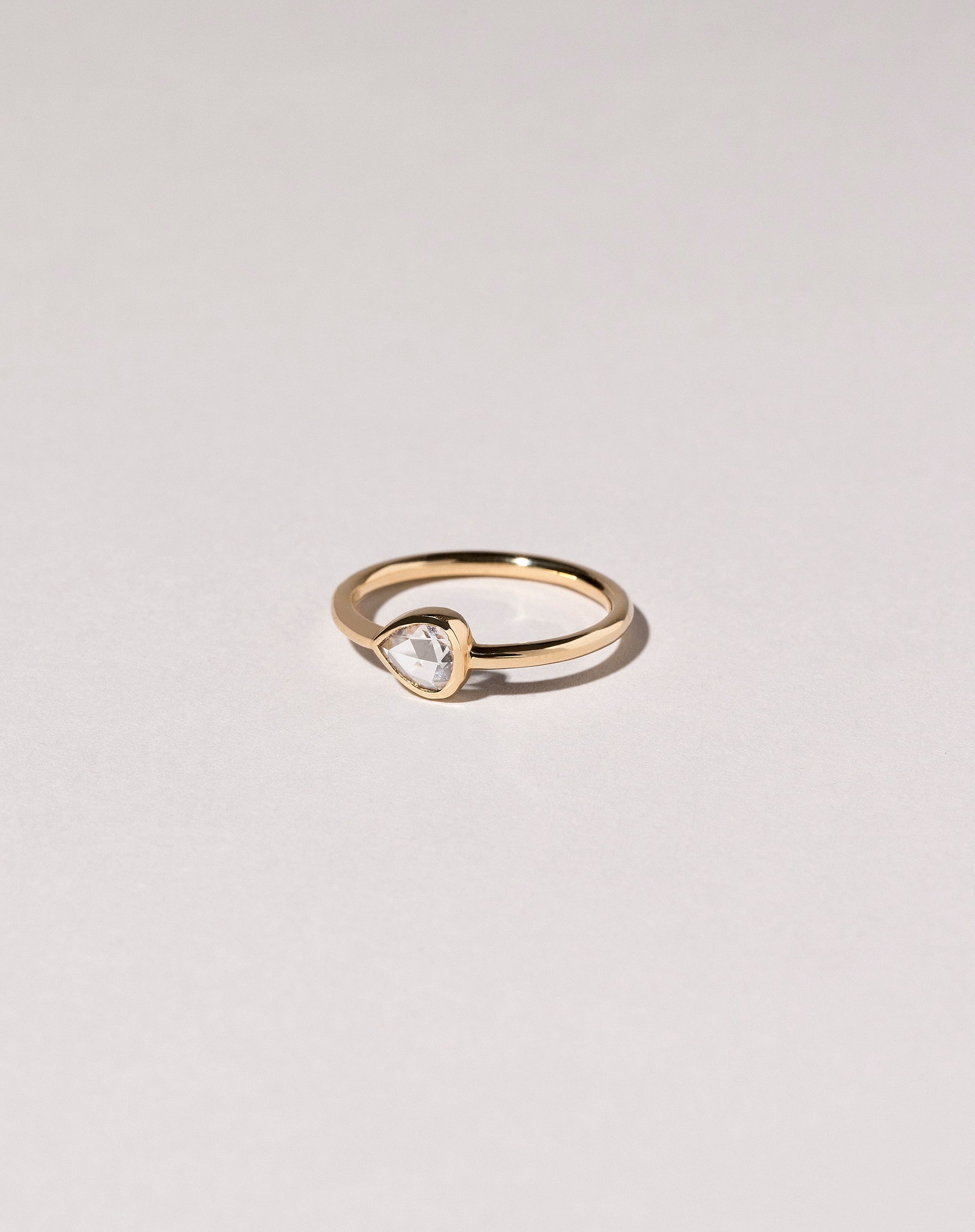 Rose Cut Pear Diamond Ring on light color background.