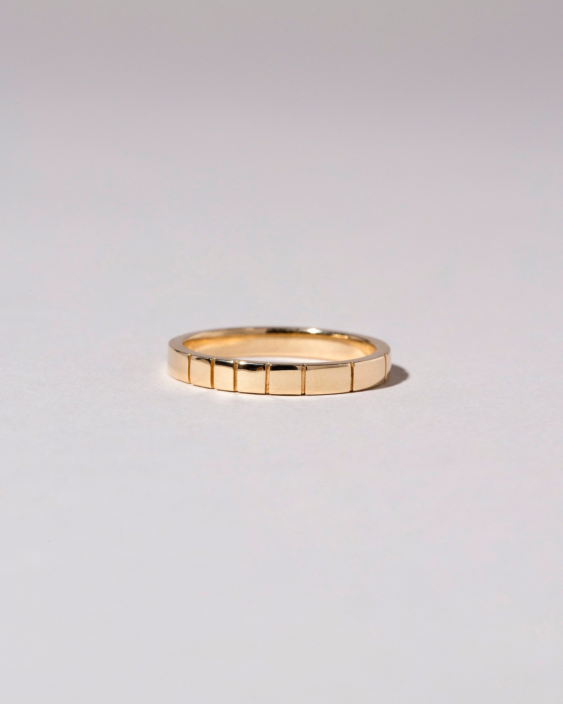 Closeup details of the Gold 2mm Etched Lines Bands on light color background.