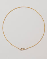 Manifestation Necklace on light color background.