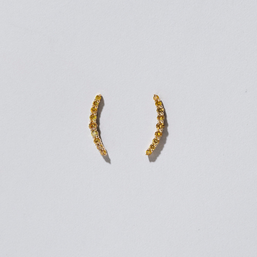 product_details::Crescent Ear Climber Stud Earrings - Yellow Diamond on light colored background.