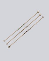 Group of White Diamond, Blue Sapphire and Emerald Consecutive Building Blocks Bracelets on light color background.