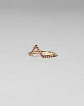 View from the side of the Red Anthill Garnet Pavé Triangle Band on light color background.