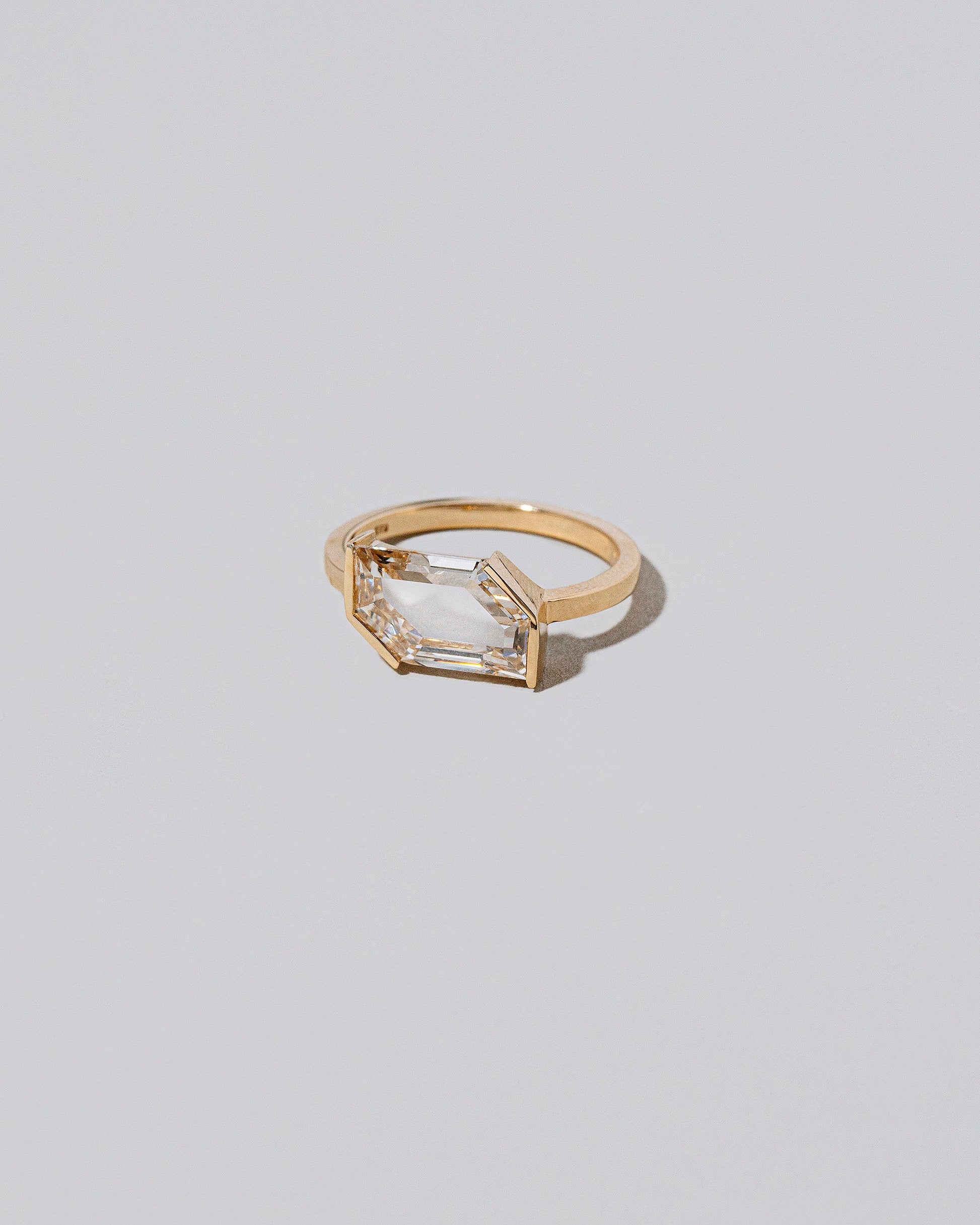 View from the side of the Heart & Soul Ring on light color background.