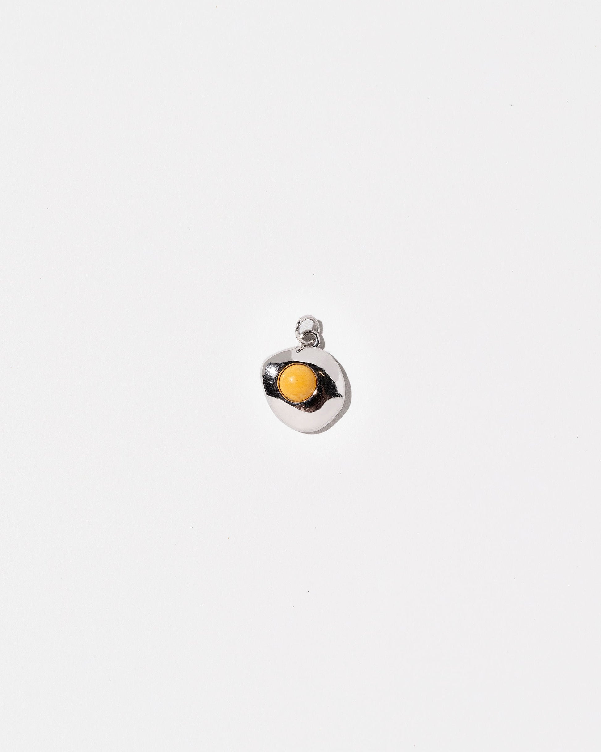 Sunny Side Up Egg Charm Seven on light colored background.