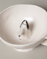 Closeup detail of the Eleonor Boström Dog Cup on light color background.