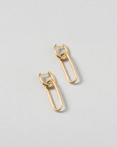 Solid Link Huggie Hoop Earrings on light color background.