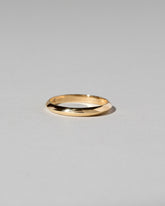 Gold 2mm Knife Edge Band on light color background.