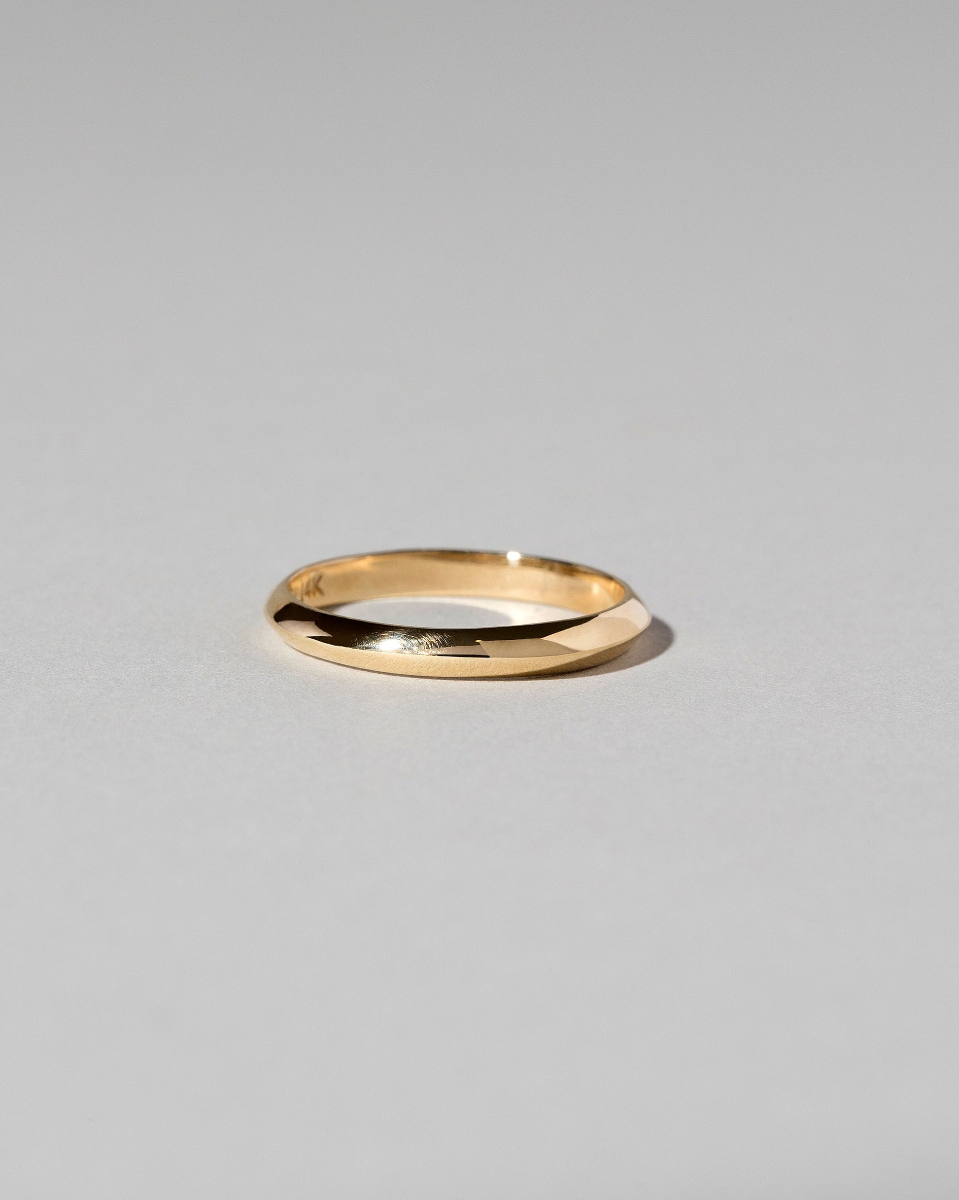 Gold 2mm Knife Edge Band on light color background.