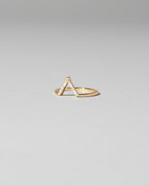 View from the side of the Gold Baguette Triangle Band on light color background.