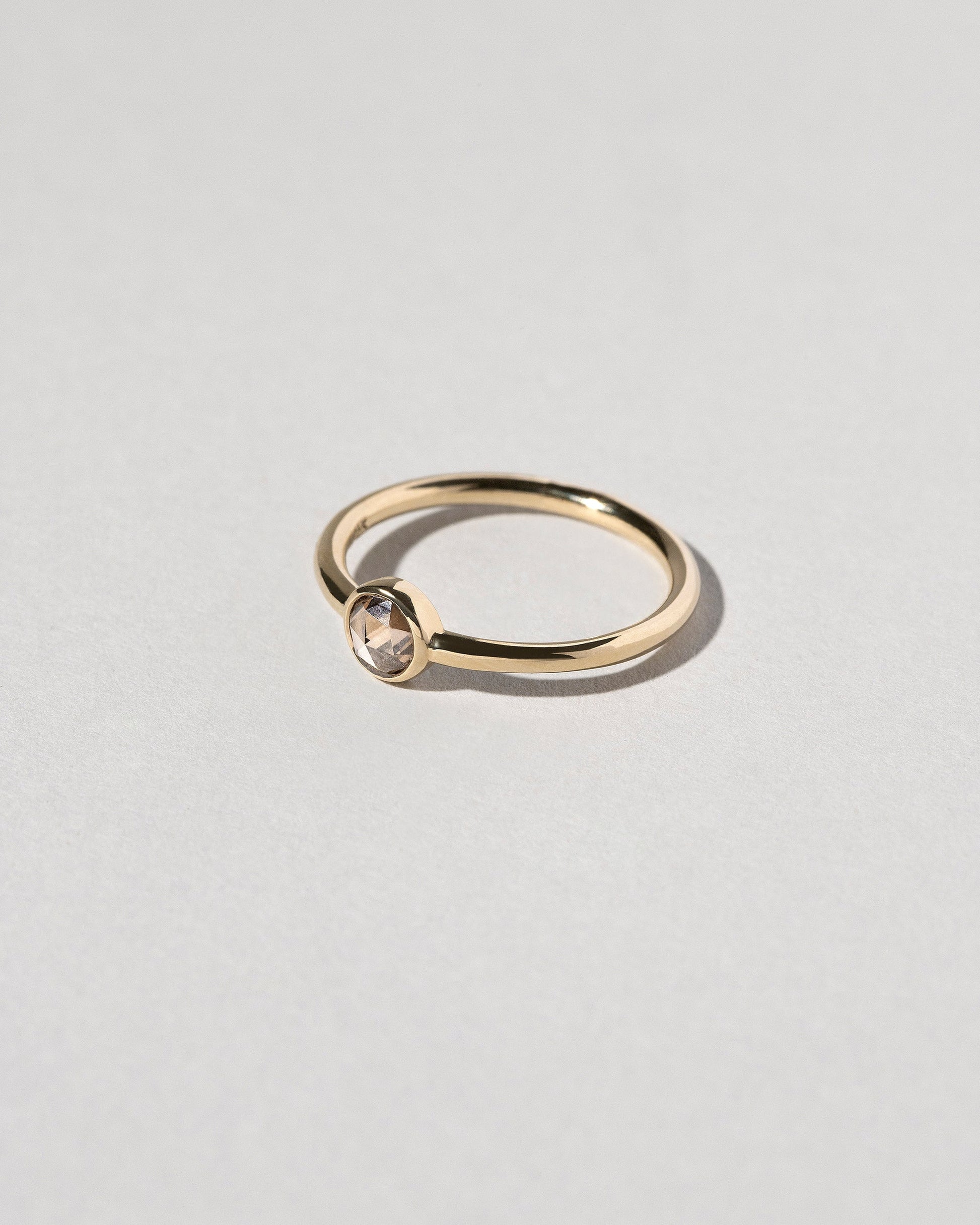 View from the side of the Rose Cut Champagne Diamond Ring on light color background.