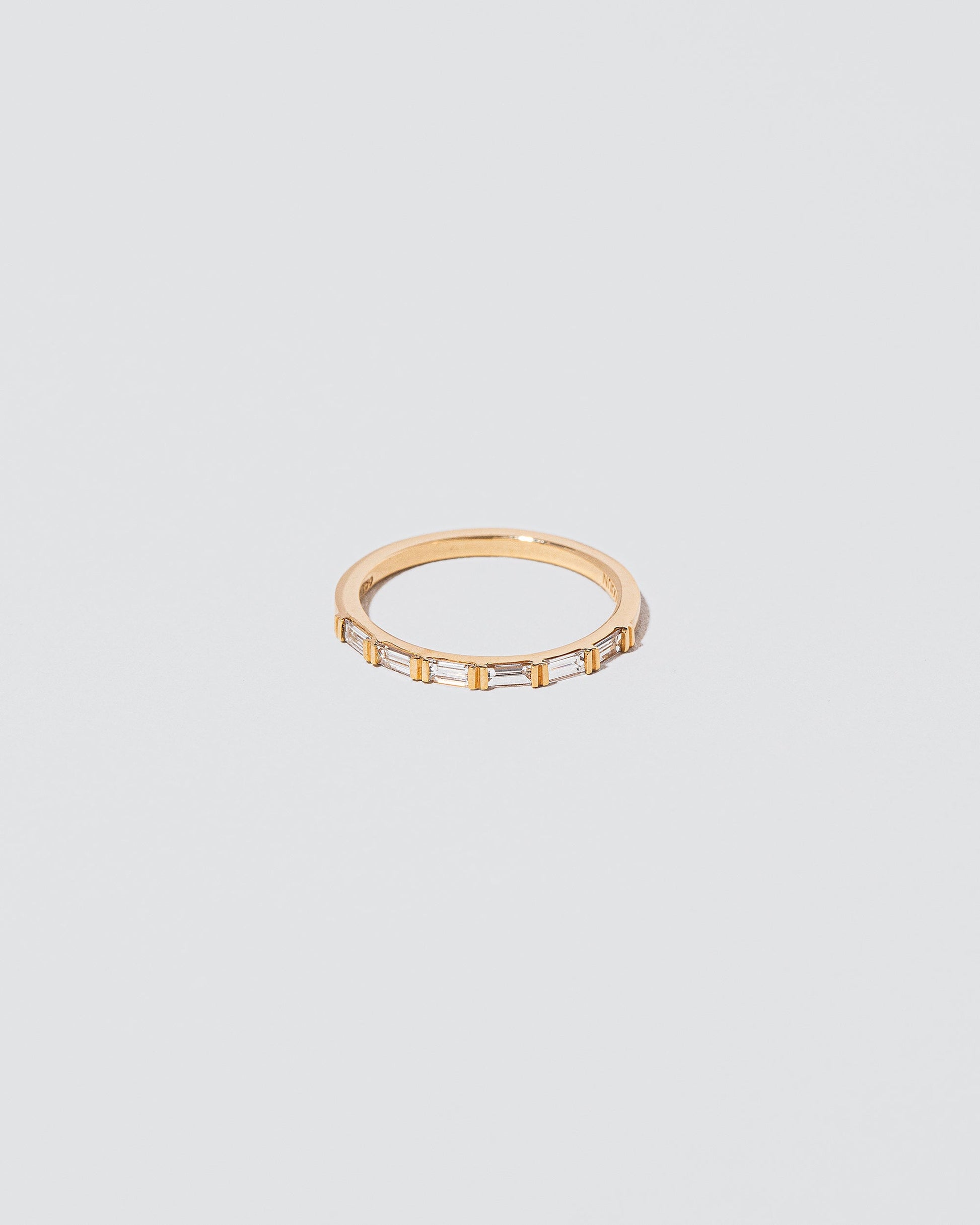 Gold White Diamond Bar Baguette Band on light color background.
