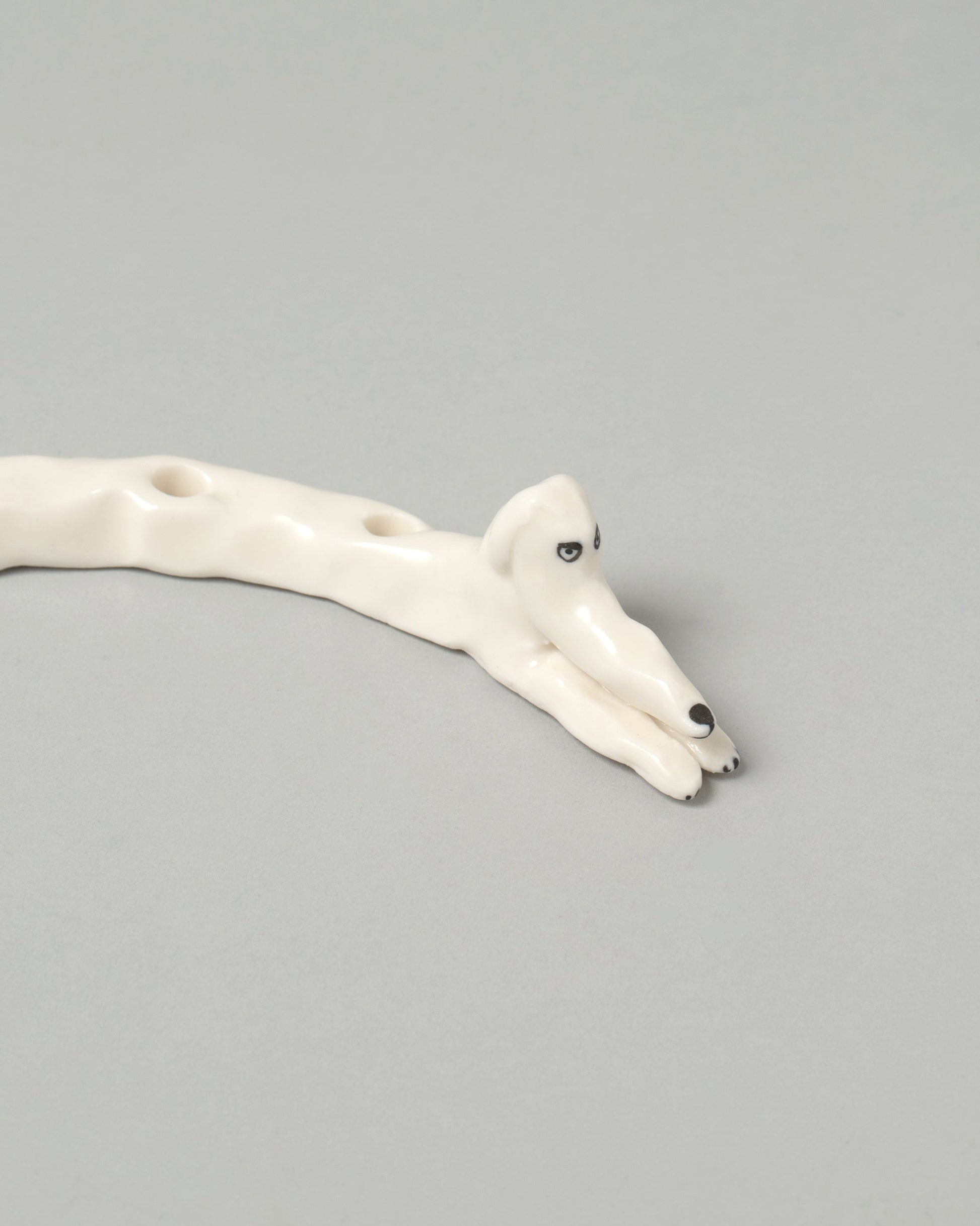 Closeup detail of the Eleonor Boström White Ears Dog Menorah on light color background.