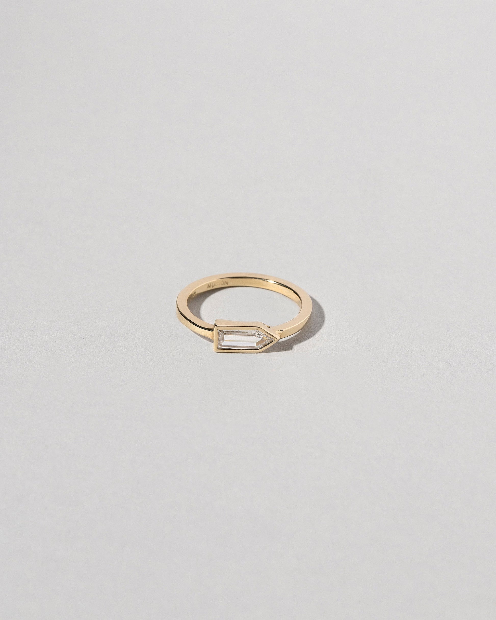 Bullet Cut Diamond Ring on light color background.