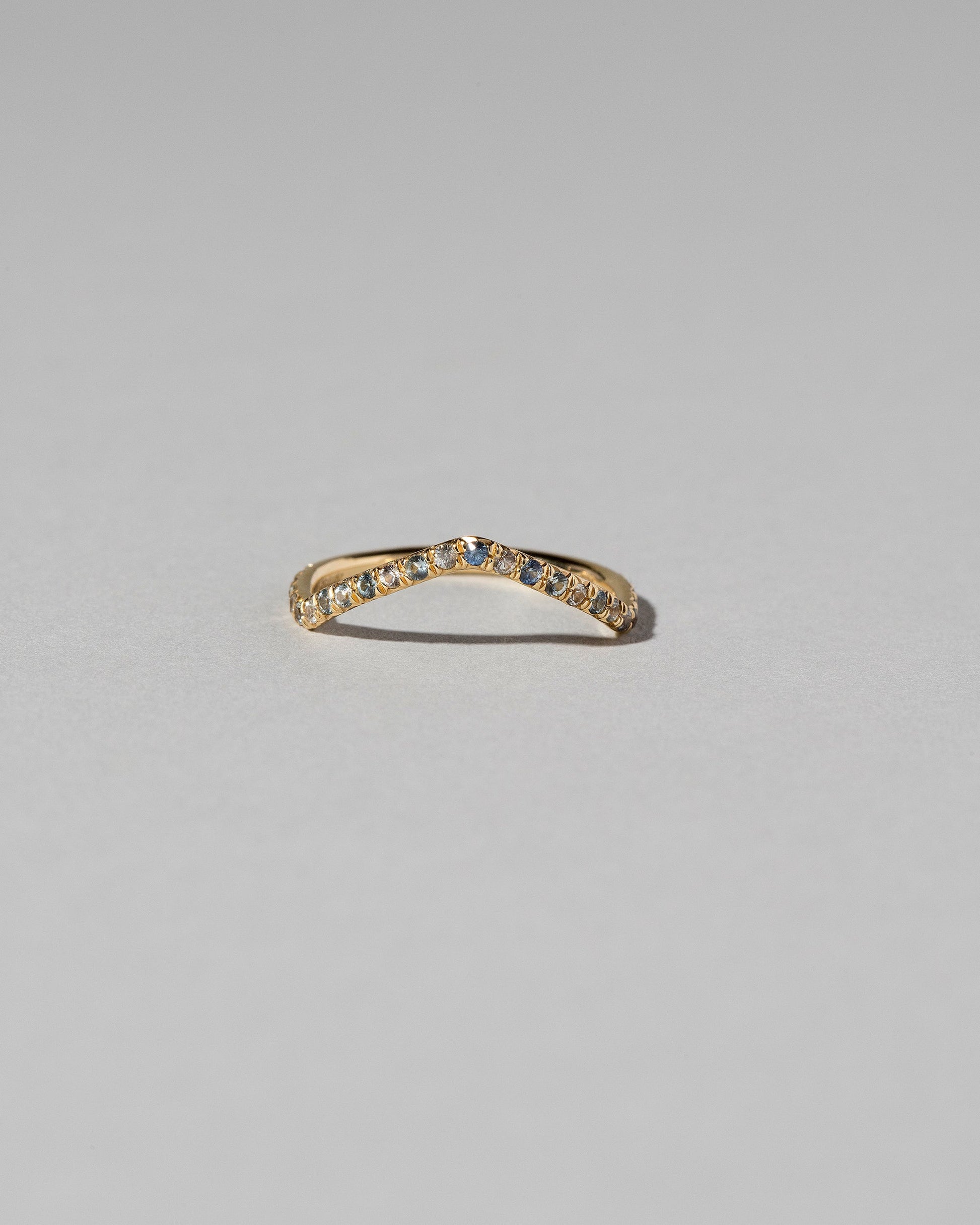 Gold Pavé Blue Sapphire Low Peak Band on light color background.