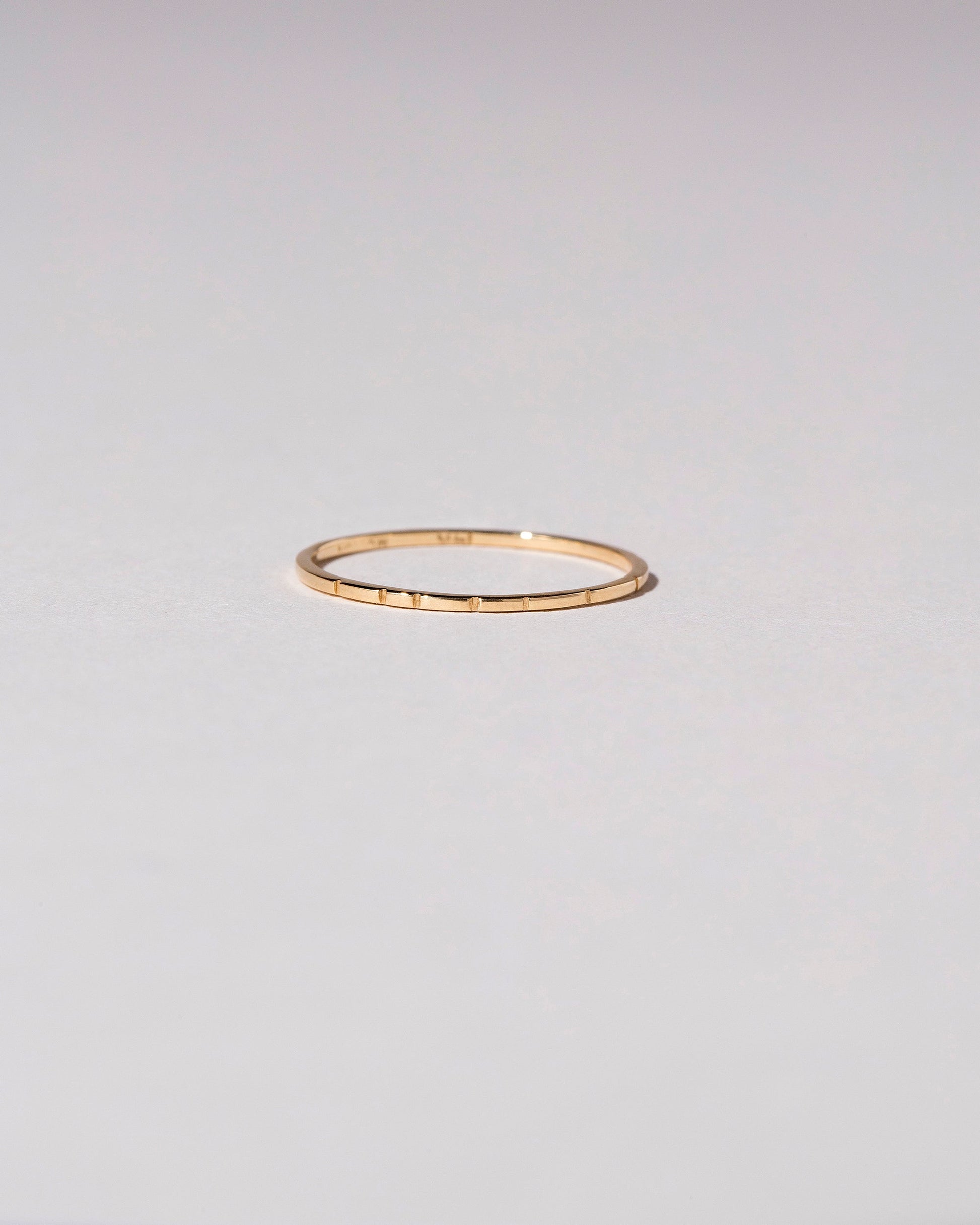 Gold 1.5mm Etched Lines Band on light color background.