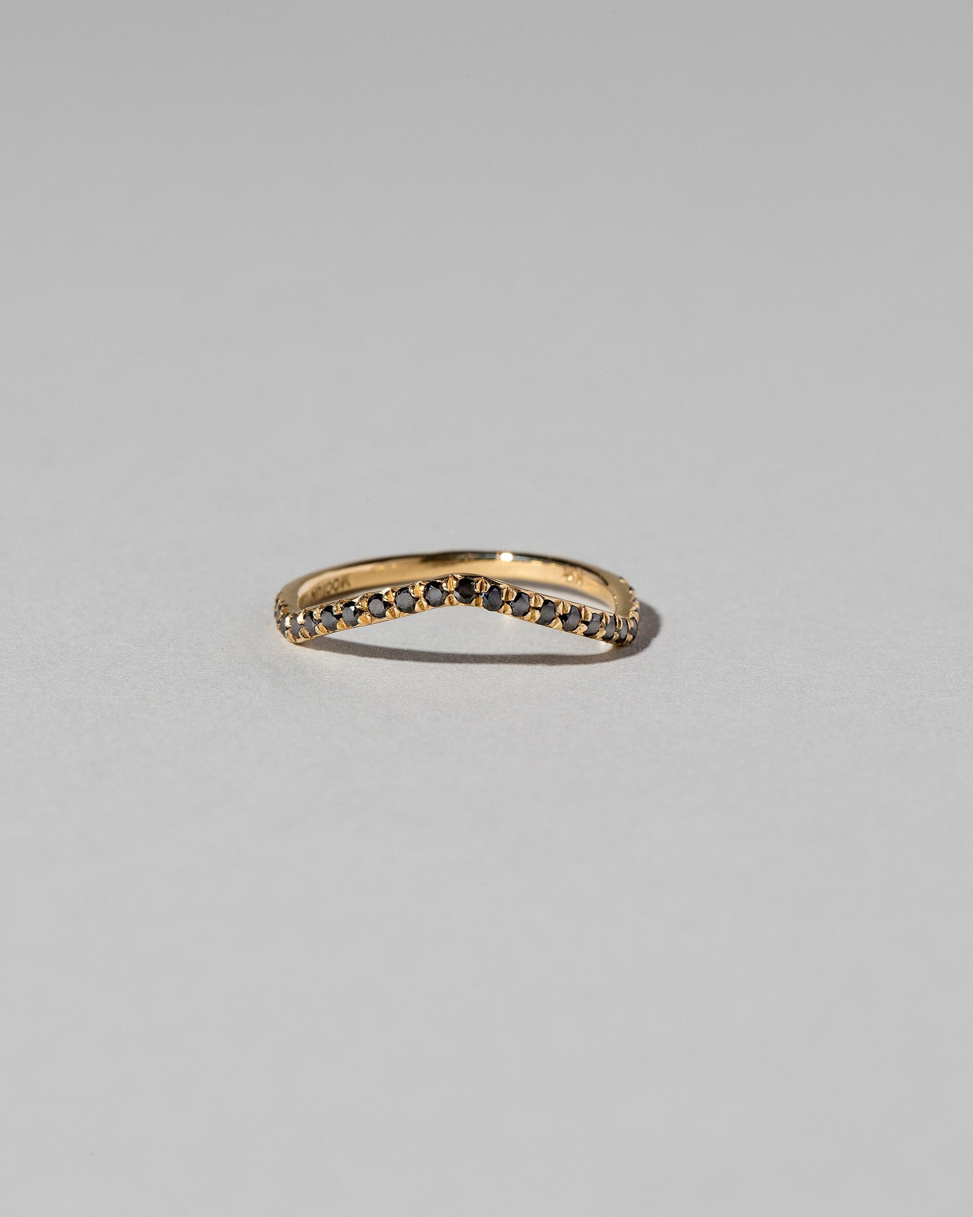 Gold Pavé Black Diamond Low Peak Band on light color background.