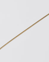 Closeup details of the 2.4mm Curb Chain Bracelet on light color background.