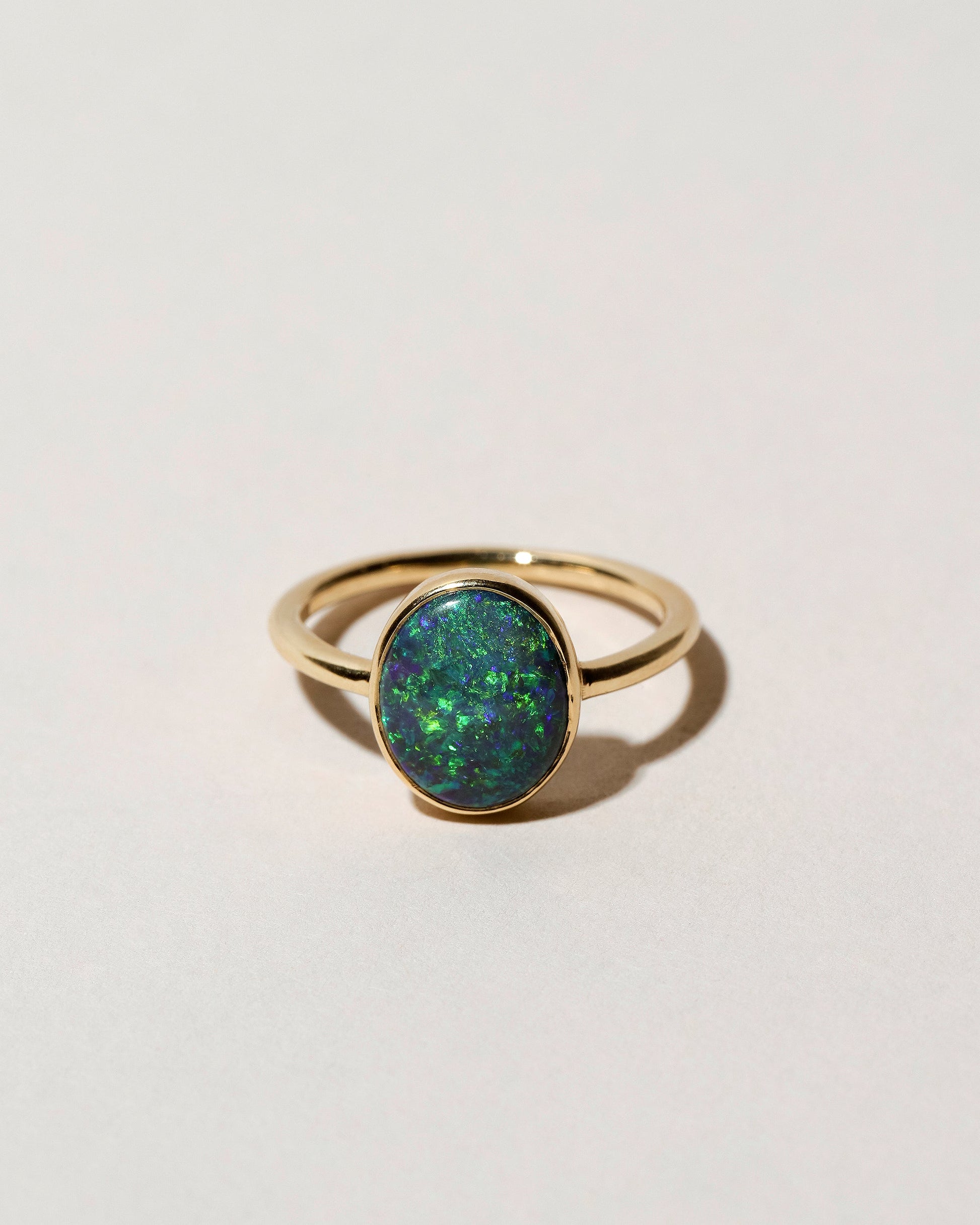 Australian Black Opal Ring on light color background.