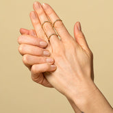 product_details::Gold Single Stone Low Peak Bands on model.