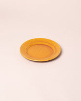 Closeup details of the La Ceramica Vincenzo Del Monaco Caramel Yellow Dessert Dish on light color background.