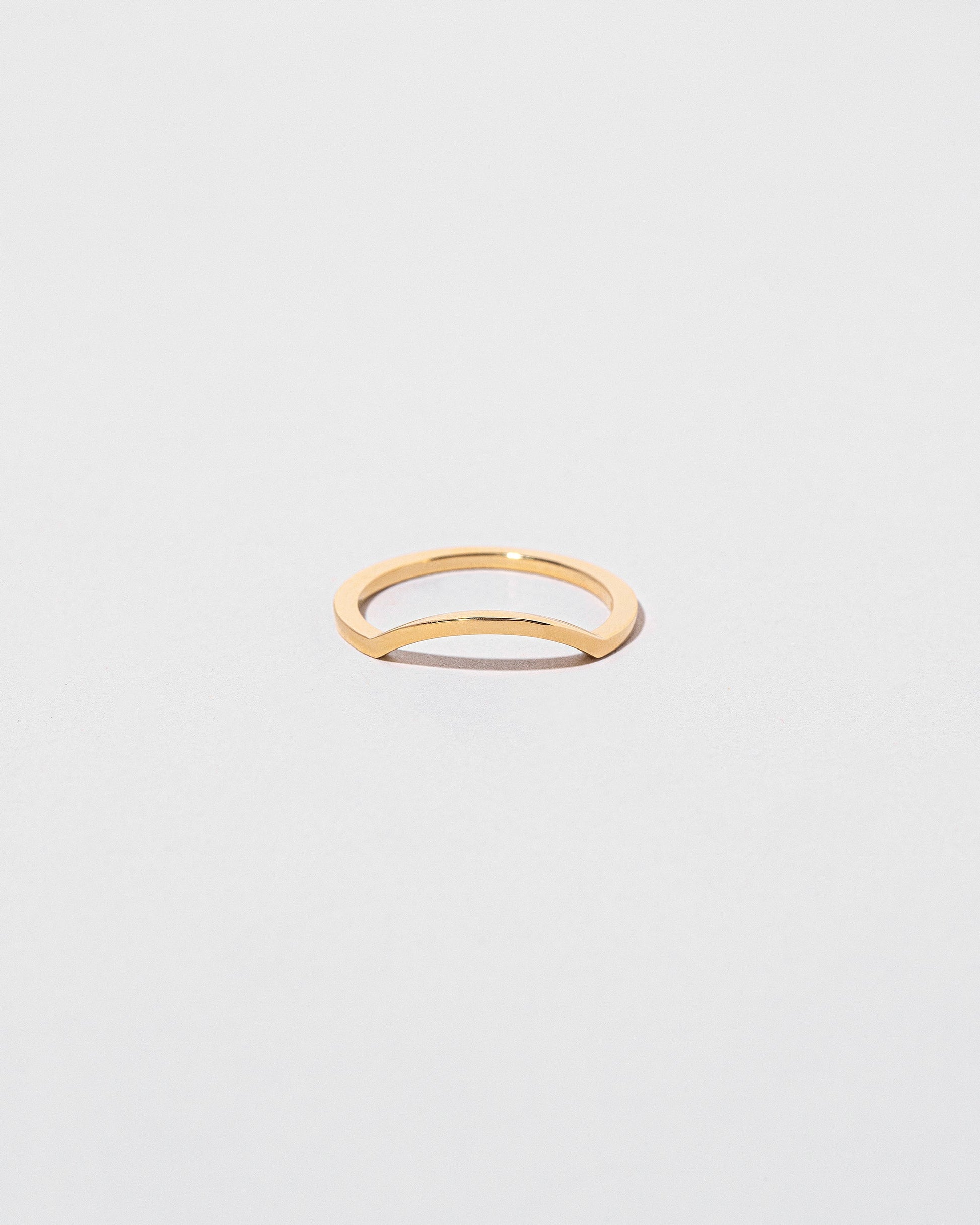 Gold Square Wire Mini Curve Band on light color background.