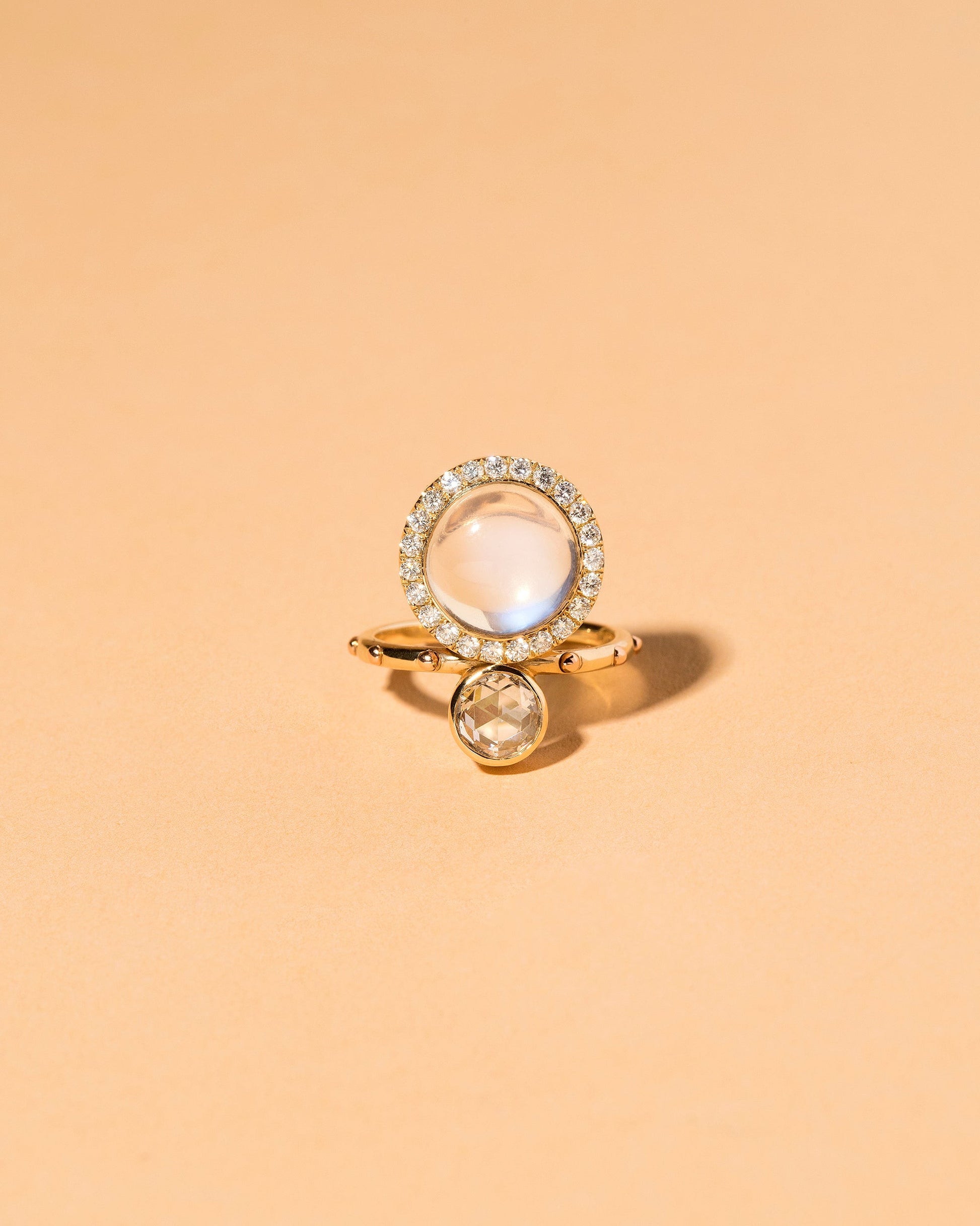 Moonstone & Diamond Cluster Ring on light color background.