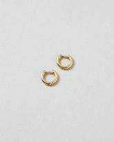 Gold Huggies Solid Snack Hoops on light color background.