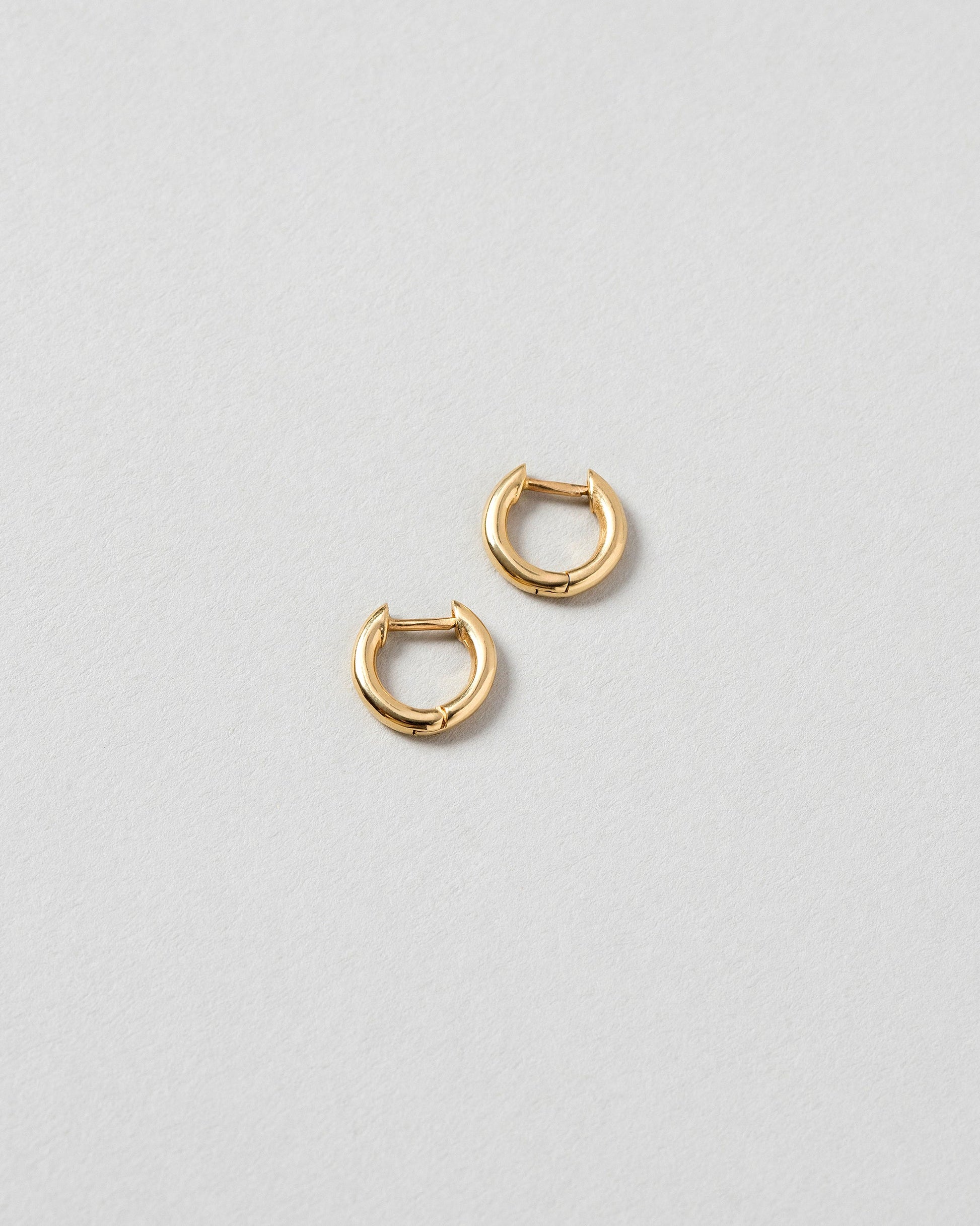 Gold Huggies Solid Snack Hoops on light color background.