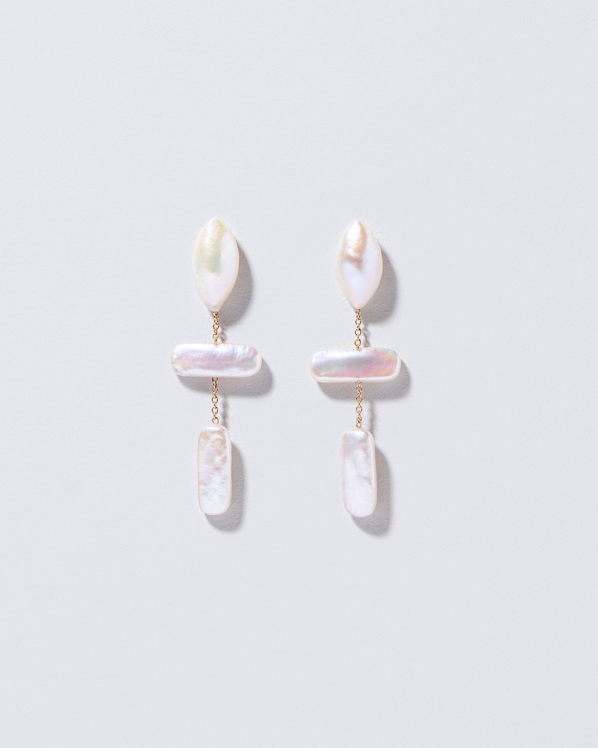  Nauplius Earrings on light color background.