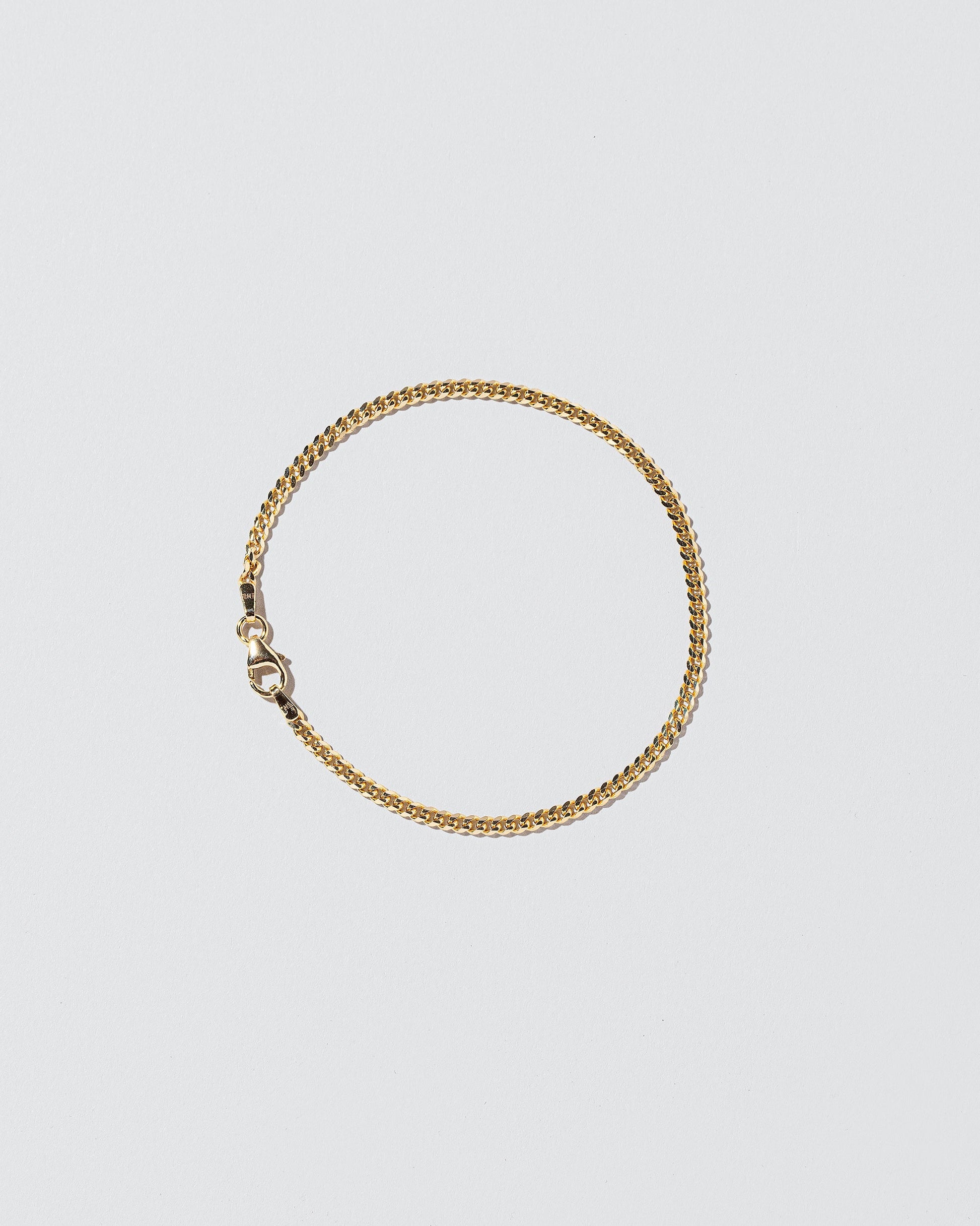 2.4mm Curb Chain Bracelet on light color background.